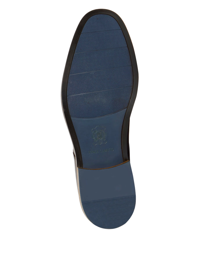 The image features the blue sole of the Men’s Lyre Derby by Vince Camuto, highlighted by a slightly darker leather heel and a logo stamped near the center, evoking a sense of timeless style.