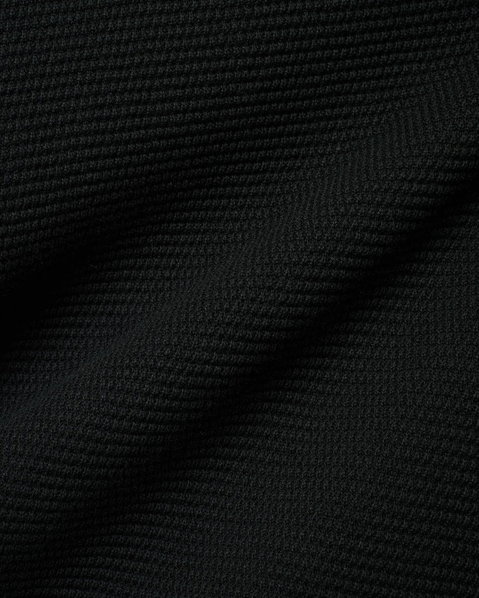 Black Makai Textured Knit T-Shirt, a premium streetwear garment featuring a distinct, small-scale horizontal textured knit pattern, reflecting Psycho Bunny's refined aesthetic.