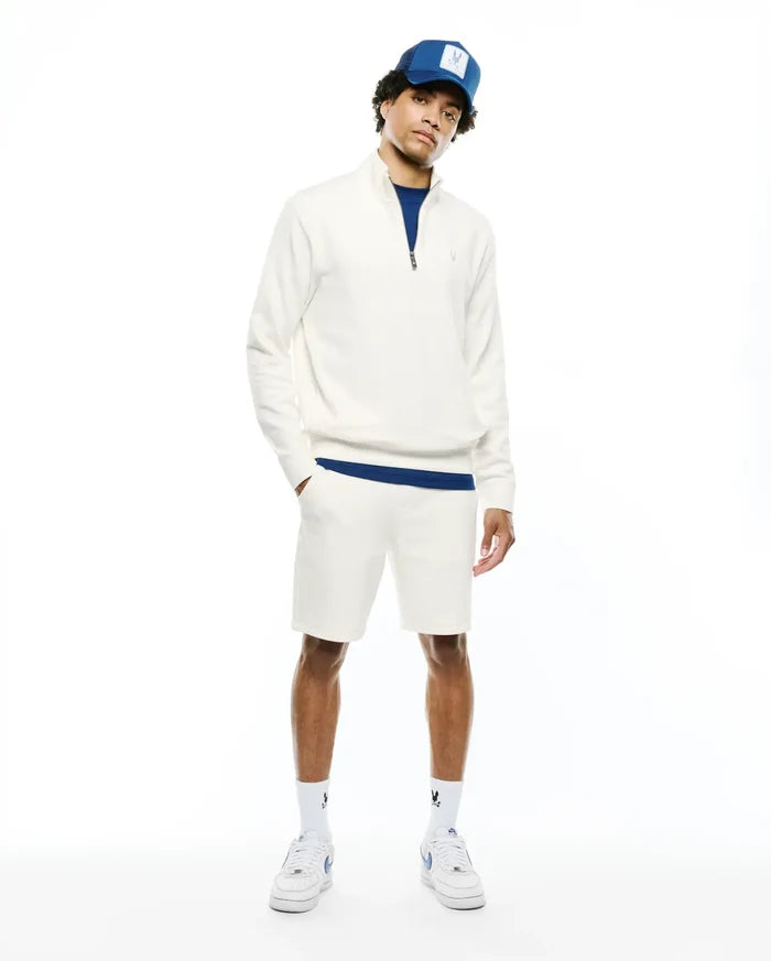 Mens Marc Textured 1/4 Zip in cream, a classic fit textured knit pullover with a small embroidered Psycho Bunny skull logo on the chest, accented by royal blue underlayer and matching shorts.