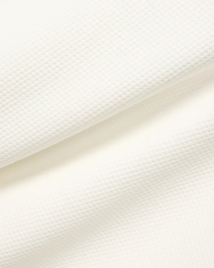 Mens Marc Textured 1/4 Zip in cream, showcasing a premium, subtly textured pique knit fabric with a fine, raised geometric pattern.