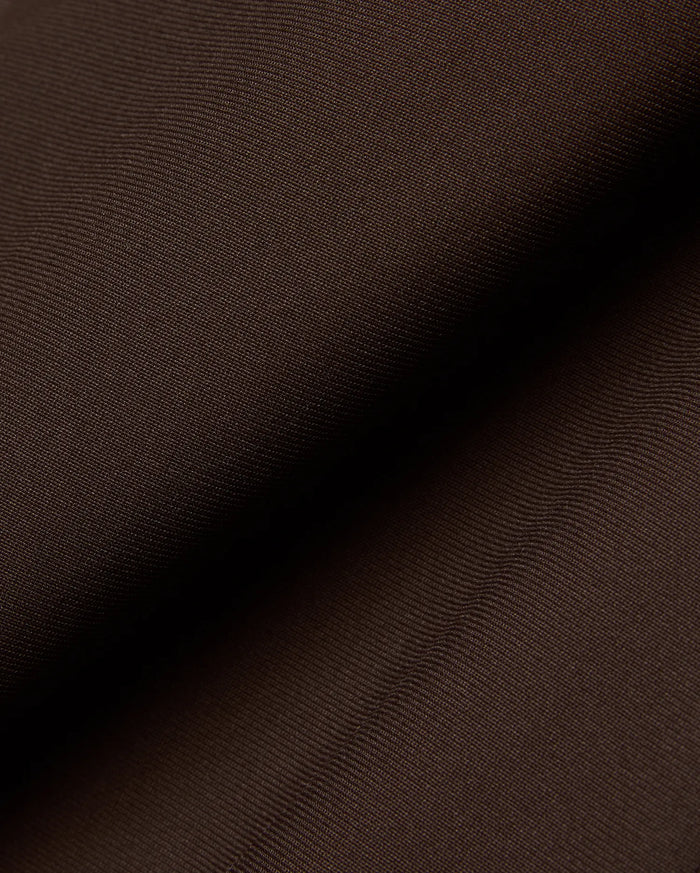 Mens Maverick 10k Step Pant in rich dark brown, featuring a finely woven, subtly textured fabric, reflecting Psycho Bunny's refined streetwear aesthetic.