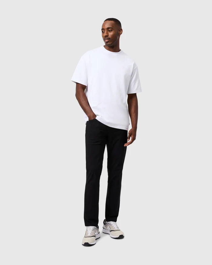 White relaxed-fit jersey t-shirt with a small embroidered Psycho Bunny logo on the left chest, paired with black slim-fit Mens Maverick 10k Step Pant 31 1/2 L.