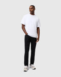 White relaxed-fit jersey t-shirt with a small embroidered Psycho Bunny logo on the left chest, paired with black slim-fit Mens Maverick 10k Step Pant 31 1/2 L.