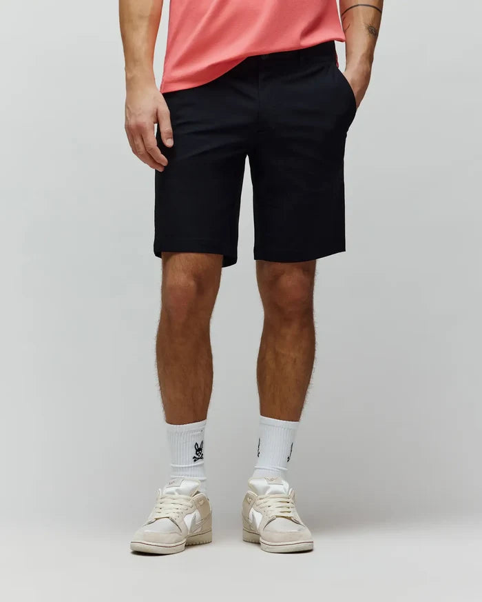 Mens Maverick 10k Step Short, a classic fit black performance stretch short with a smooth, refined finish, featuring a flat front, belt loops, slash pockets, and an above-the-knee length.