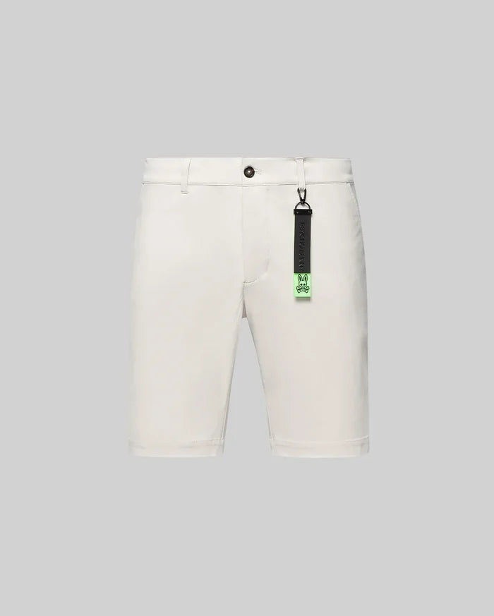 Cream Mens Maverick 10k Step Short, classic fit, smooth woven fabric, featuring button closure, belt loops, and a distinctive black and neon green Psycho Bunny skull logo keychain.
