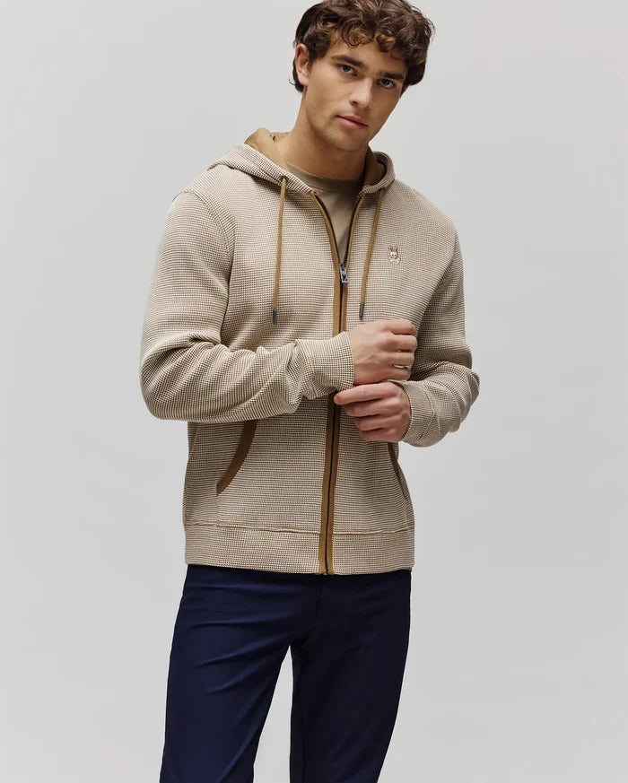 Mens Maxton Waffle Full Zip Hoodie in beige and white micro-check waffle knit, featuring a classic fit, brown trim, drawstrings, and a small embroidered Psycho Bunny skull logo on the left chest.