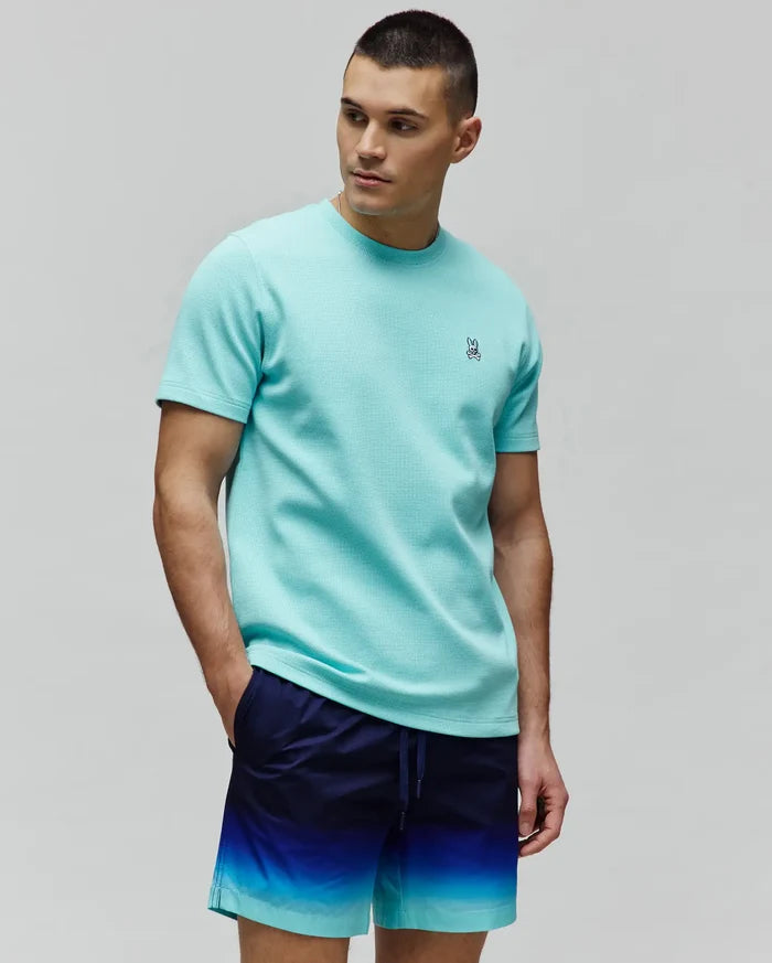 Mens Maxton Waffle Tee in aqua, featuring a classic fit and textured waffle knit fabric with a small, embroidered Psycho Bunny skull logo on the left chest.