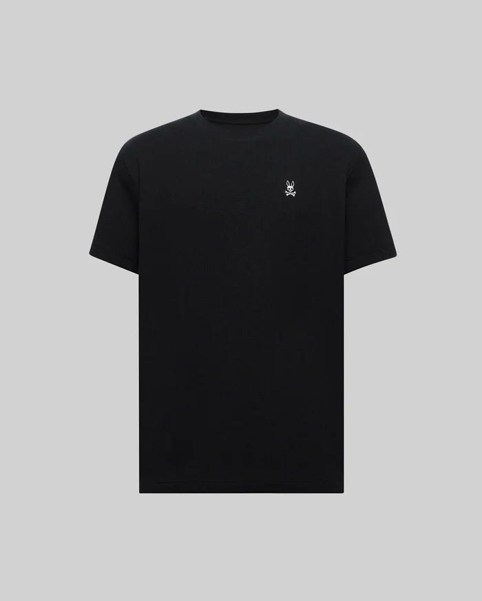 Mens Maxton Waffle Tee, a premium classic fit black waffle knit t-shirt featuring a small, crisp white embroidered Psycho Bunny skull logo on the left chest.