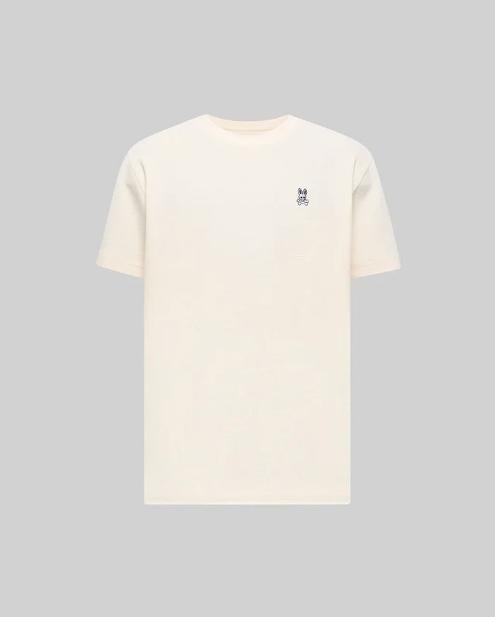 Mens Maxton Waffle Tee in cream, featuring a classic fit and textured waffle knit fabric, with a small embroidered dark blue Psycho Bunny skull logo on the left chest.