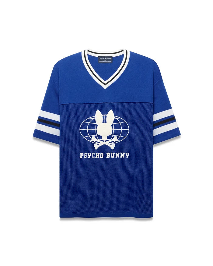 Royal blue Mens Mike Knit Graphic Jersey, relaxed fit, with white/black striped knit V-neck and sleeves. Features a large white Psycho Bunny skull globe graphic and text on the mesh-textured chest.