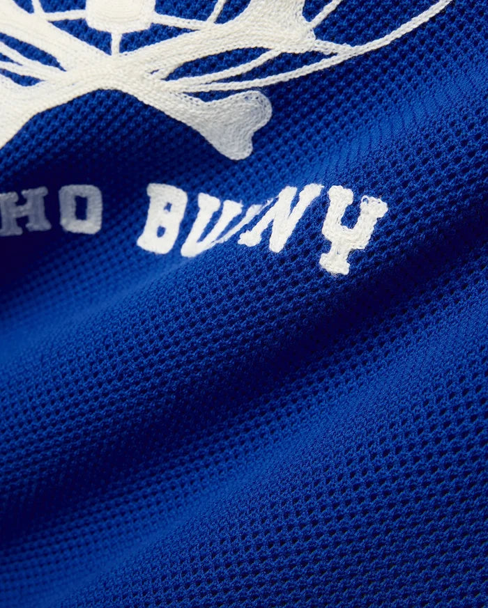 Mike Knit Graphic Jersey in royal blue, featuring a large white knit Psycho Bunny skull graphic and text on a breathable mesh fabric.