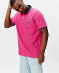 Mens Nate Pique Polo in hot pink, classic fit, pique fabric, with black ribbed collar and cuffs featuring white tipping, and a small embroidered multi-color Psycho Bunny skull logo on the left chest.