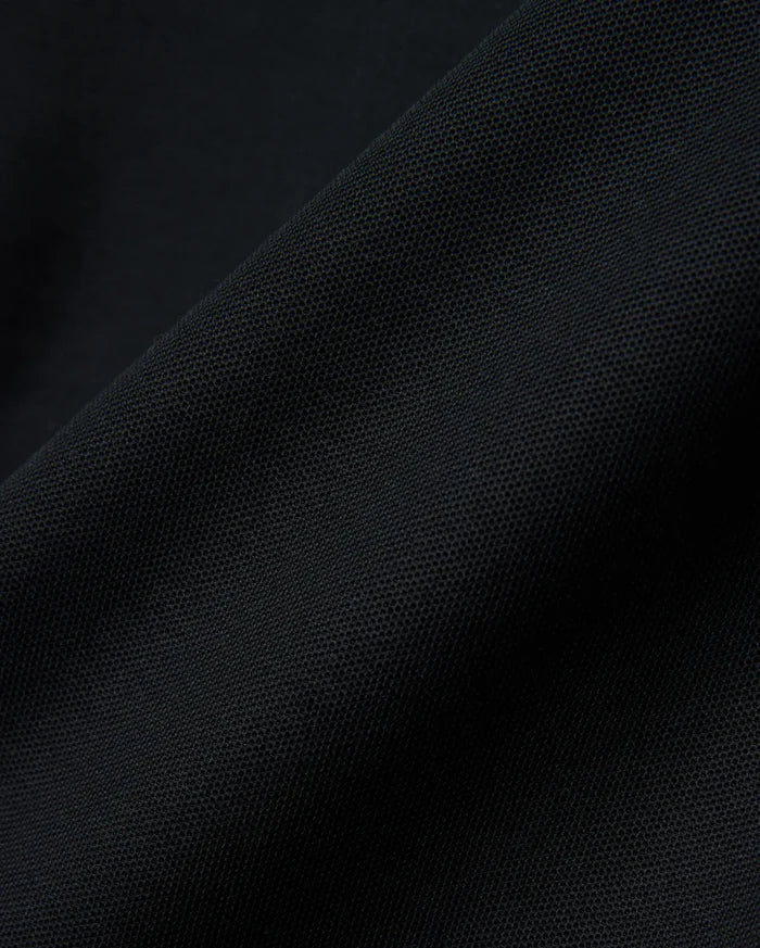 Black MENS NATE PIQUE POLO, a classic fit staple, featuring a refined textured pique weave and the iconic small embroidered Psycho Bunny skull logo on the left chest.