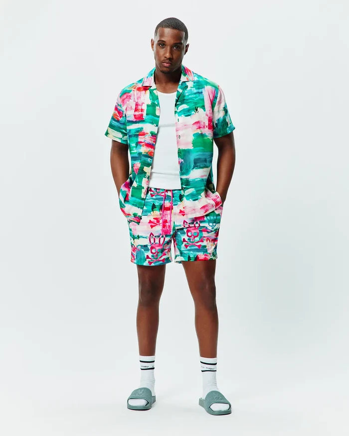 Vibrant abstract multi-color print short-sleeve shirt and MENS NATE ALL OVER PRINT SWIM TRUNK. Shirt features an embroidered Psycho Bunny skull; trunks display an all-over skull graphic.