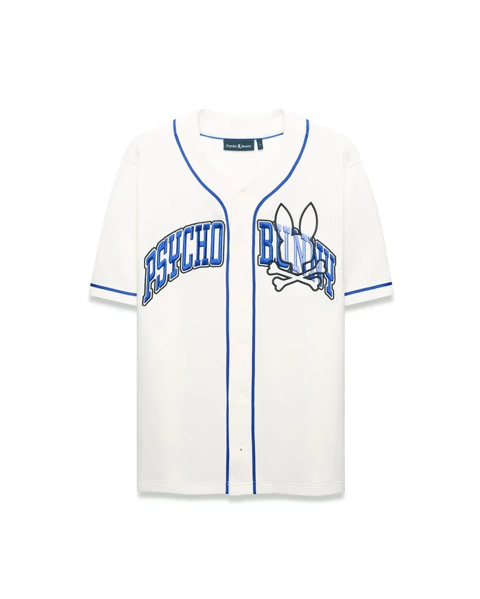 Mens Nathaniel Baseball Shirt, cream relaxed fit jersey with blue piping, featuring a large embroidered PSYCHO BUNNY text and bunny skull crossbones graphic on the chest.
