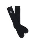 Mens Nathaniel Dress Sock, a pair of premium black ribbed knit dress socks featuring the iconic small white embroidered Psycho Bunny skull logo prominently placed near the cuff.