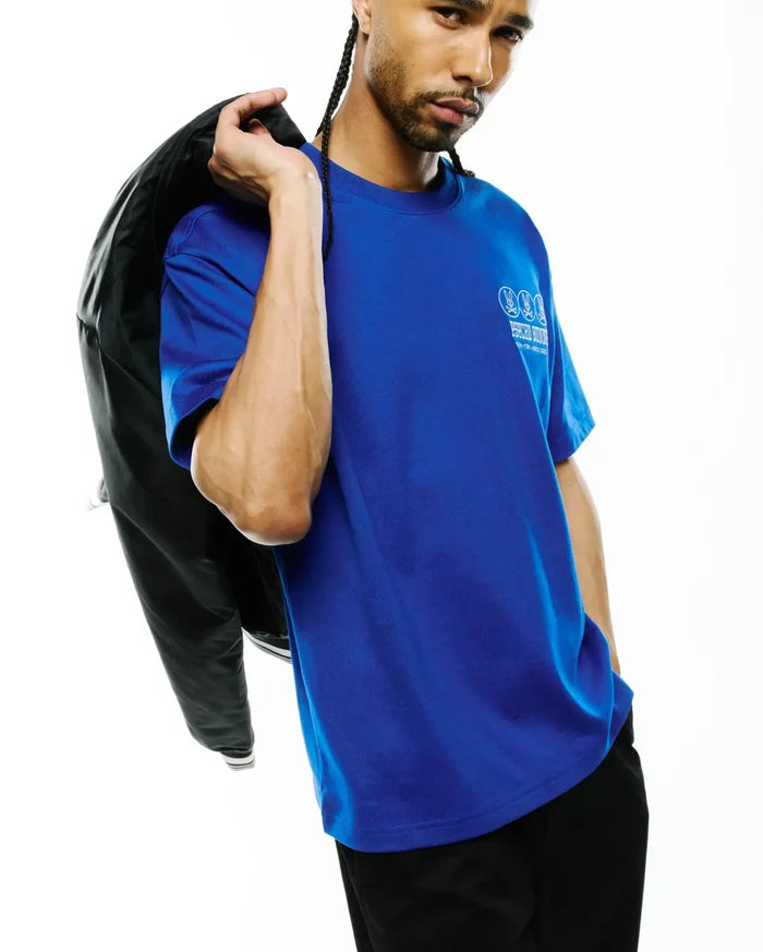 Mens Nathaniel Relaxed Fit Tee, a vibrant royal blue jersey knit with a relaxed fit, showcasing a prominent white Psycho Bunny triple skull logo and brand text on the left chest, embodying refined streetwear.