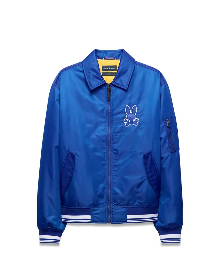 Mens Nathaniel Satin Coach Jacket, royal blue satin, full-zip, ribbed cuffs/hem with white stripes, zippered sleeve pocket, and large white embroidered Psycho Bunny skull logo on left chest.