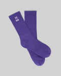 MENS NEW CLASSIC SPORT SOCK, a vibrant purple crew sock featuring a prominent white embroidered Psycho Bunny skull logo on the ribbed cuff, embodying refined streetwear style.