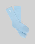 Mens New Classic Sport Sock, light blue, with a white embroidered Psycho Bunny skull logo prominently displayed on the ribbed cuff, featuring a smooth knit body.