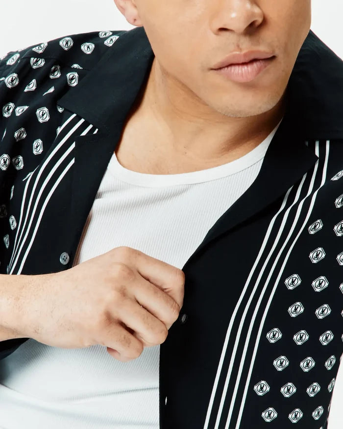 Mens Nick Tencel Shirt, black with a white all-over Psycho Bunny skull logo print and bold vertical white stripes, offering a relaxed fit in smooth Tencel fabric.