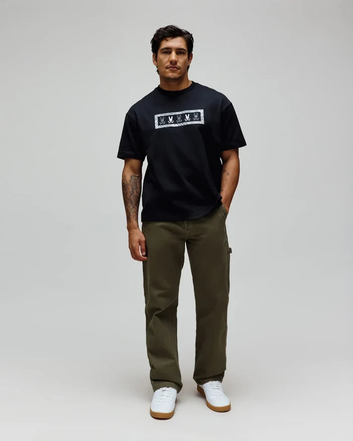 Mens Olivier Oversized Tee in black jersey, featuring a bold white rectangular chest graphic with an intricate bandana-style border and repeated Psycho Bunny skull logos.