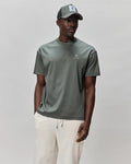 Mens Oscar Oversized Tee in muted sage green, featuring a smooth jersey texture and a small, white embroidered Psycho Bunny skull logo on the left chest.