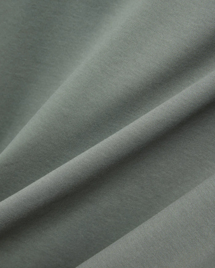 MENS OSCAR OVERSIZED TEE, a premium oversized tee in a rich sage green, featuring a finely textured, soft jersey knit fabric with elegant drapes and subtle sheen.