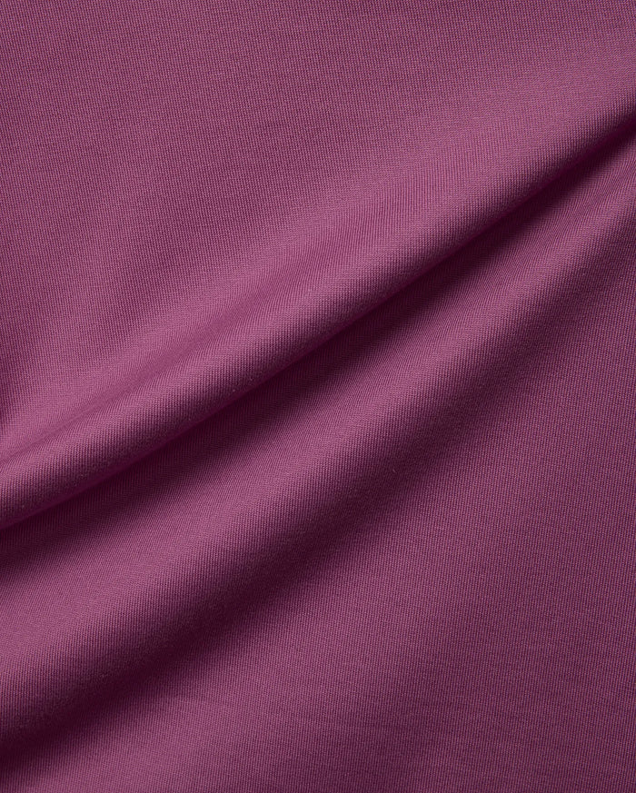 Psycho Bunny Mens Oscar Relaxed Fit Tee in a rich plum jersey knit fabric, showcasing a soft, finely textured surface with gentle drapes.