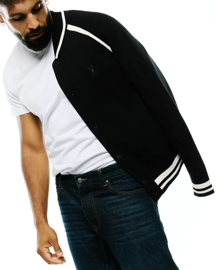 Black Mens Rafferty Cardigan, a classic knit cardigan with white varsity stripes on the collar and cuffs, featuring a small embroidered Psycho Bunny skull logo on the left chest and snap button closure.
