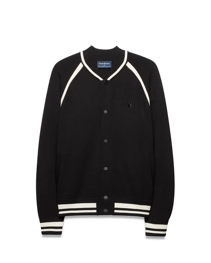 Mens Rafferty Cardigan: Black knit varsity cardigan with white stripe accents on ribbed collar, raglan sleeves, cuffs, and hem, featuring snap buttons and a small embroidered Psycho Bunny skull logo on the left chest.
