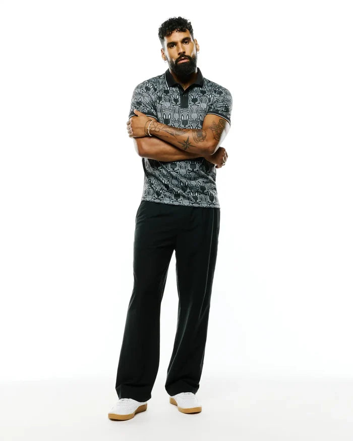 Mens Reeves All Over Bunny Sport Polo, a classic fit black and grey pique polo featuring an all-over white bunny skull pattern and crisp white trim on the collar and sleeves.
