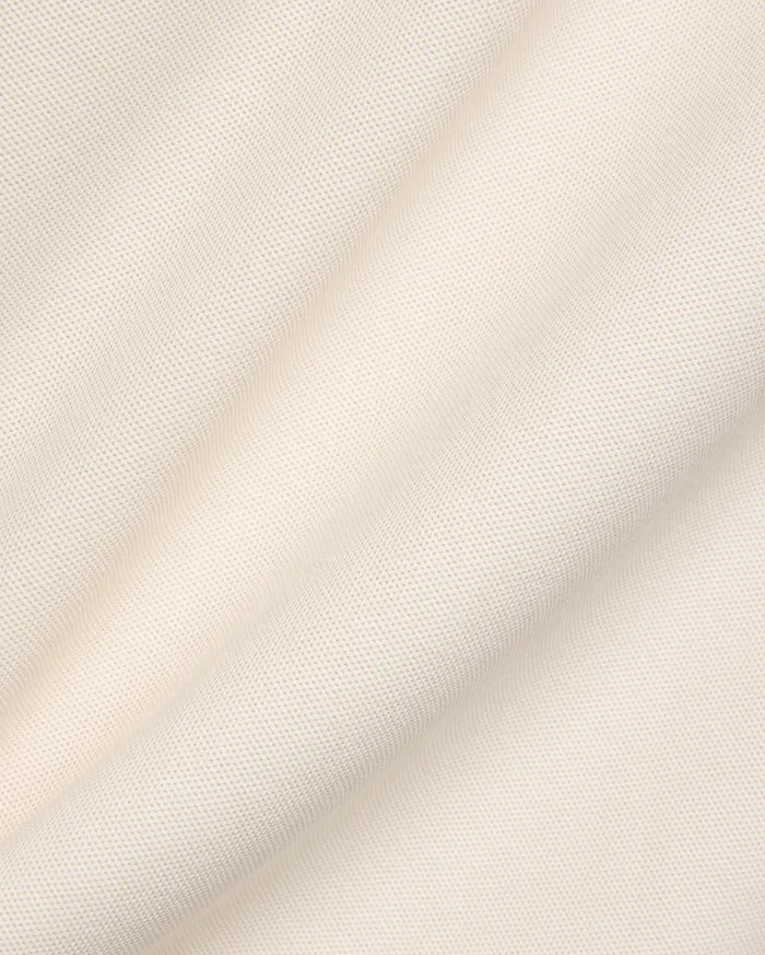 Mens Robin Pique Polo in cream, a premium Psycho Bunny garment crafted from textured pique fabric, typically featuring the iconic embroidered bunny skull logo on the chest.