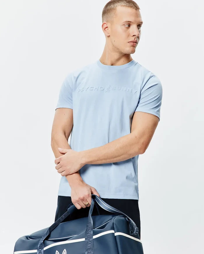 Mens Royce Graphic Tee, sky blue classic fit jersey knit t-shirt featuring a large, raised Psycho Bunny bunny skull logo and text centered on the chest.