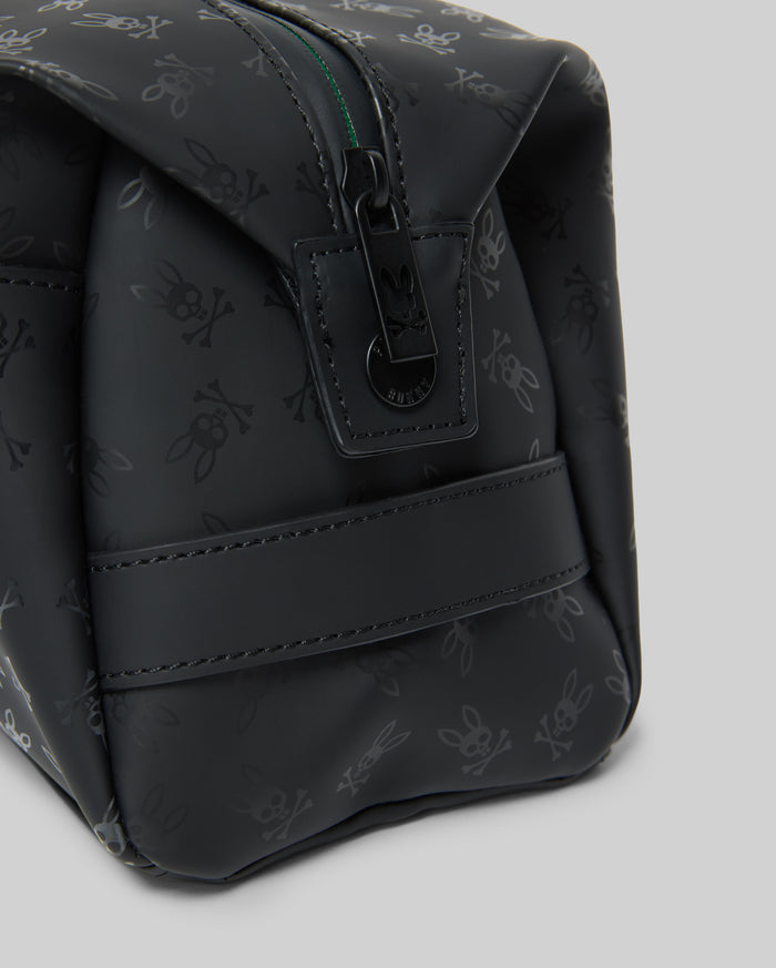 Mens All Over Bunny Toiletry Kit, black with an all-over subtle Psycho Bunny skull logo pattern, smooth texture, top zipper closure with branded pull, and a side strap.