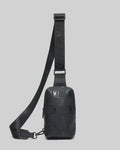 Black Mens Rubberized Crossbody with an all-over embossed checkerboard pattern featuring the iconic Psycho Bunny skull logo and an adjustable strap.