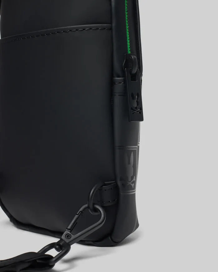 Mens Rubberized Crossbody in black with a smooth matte finish, featuring a vibrant green zipper, black metal hardware, a Psycho Bunny logo zipper pull, and an embossed logo pattern on the side.