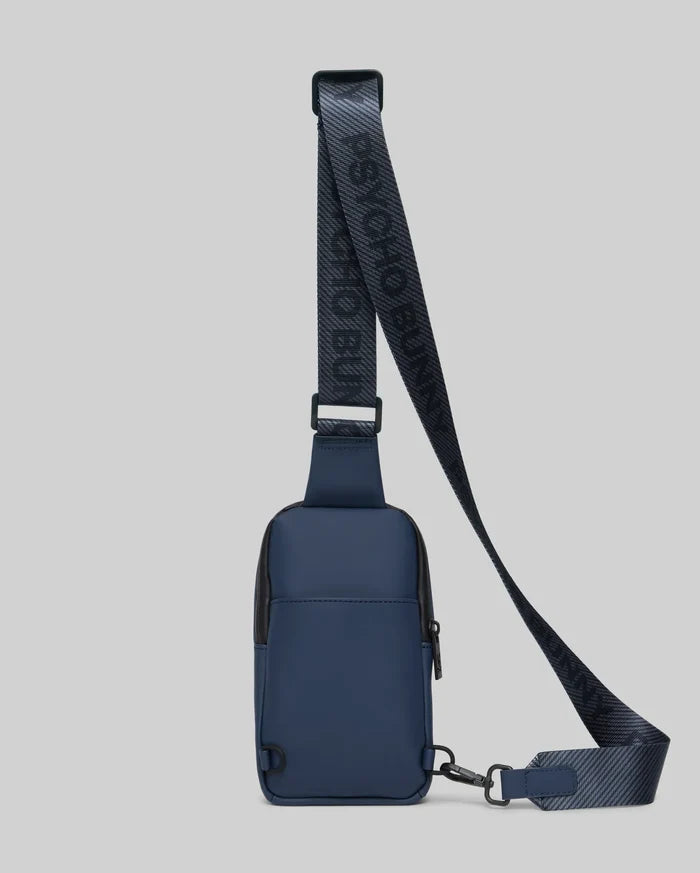 Mens Rubberized Crossbody bag in dark navy with black trim, featuring a smooth, matte finish and an adjustable woven strap with repeating dark grey Psycho Bunny text.