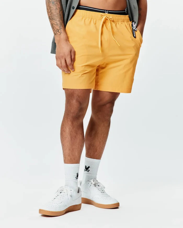 Mens Samos Hydrochromic Printed Swim Trunk in vibrant yellow, featuring a relaxed fit, drawstring waist, smooth quick-dry fabric, and a small black and white Psycho Bunny logo tag on the right pocket.