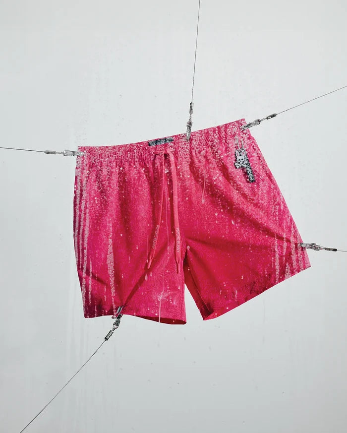 Mens Samos Hydrochromic Printed Swim Trunk 6, a hot pink relaxed fit swim trunk with a tonal pattern, white hydrochromic rain print, Psycho Bunny branded drawstrings, and a bunny skull logo charm.