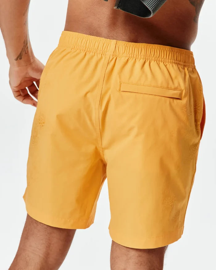 Marigold Mens Samos Hydrochromic Printed Swim Trunk with a relaxed fit, elastic waistband, and a subtle tonal Psycho Bunny skull pattern on the side, featuring a back flap pocket.