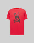 Mens Serge Embroidered Bunny Graphic Tee in vibrant red, showcasing a large central black Psycho Bunny skull and crossbones graphic with curved brand text, on a relaxed fit jersey knit.