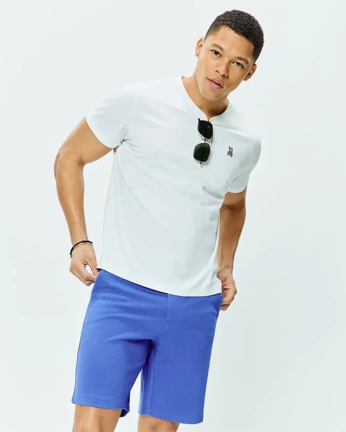 White classic fit crew neck jersey t-shirt featuring a small embroidered Psycho Bunny skull logo on the left chest, paired with vibrant royal blue MENS SHIRO TWILL SHORT.
