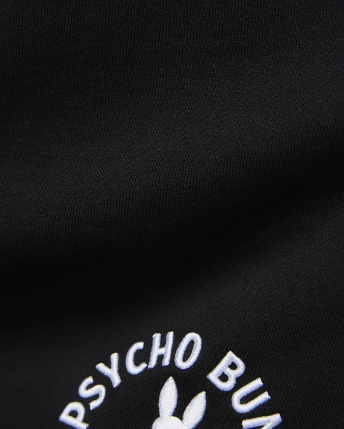 Mens Stevie Short in black, crafted from a smooth, dense knit fabric, prominently featuring the iconic white embroidered Psycho Bunny text and partial bunny skull logo.