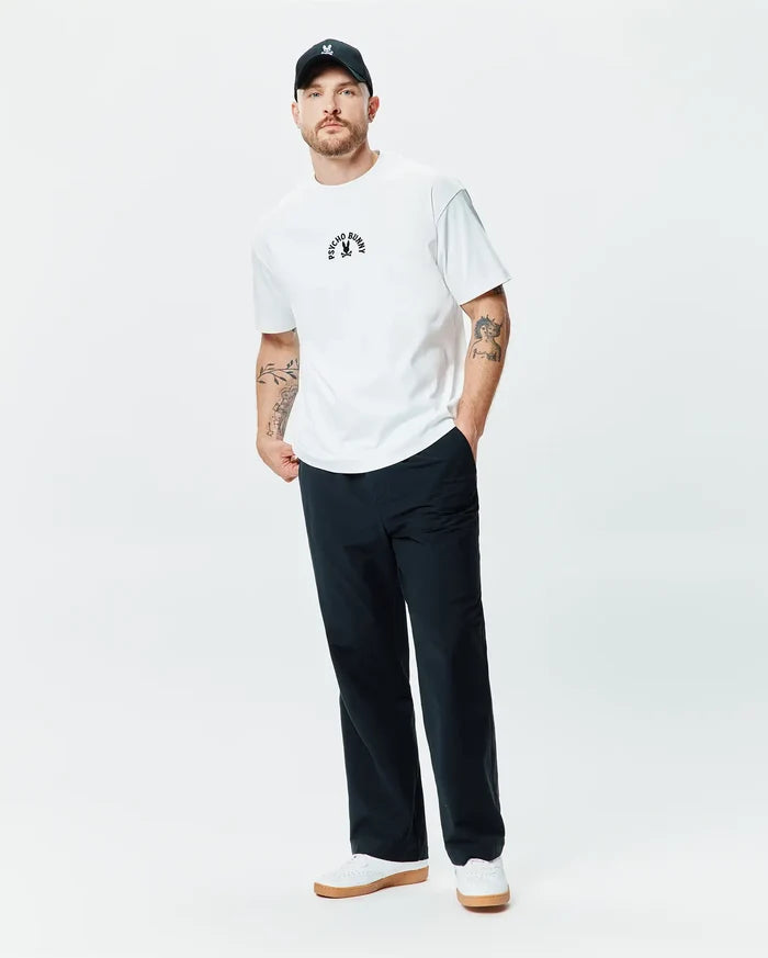 White Mens Stevie Relaxed Fit Tee in smooth jersey, featuring a small, centered black embroidered Psycho Bunny skull logo with curved Psycho Bunny text above it.