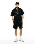 Mens Stevie French Terry Ss 1/4 Zip, black relaxed short-sleeve French terry top with white 1/4 zip, chest stripes & embroidered Psycho Bunny logo. Paired with matching black shorts, white piping, bunny skull.