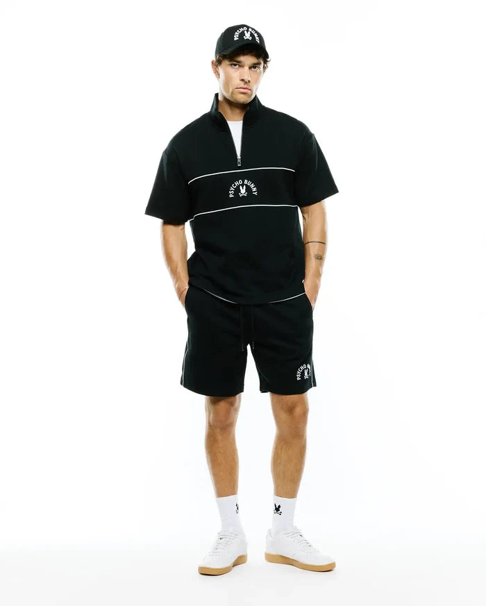 Mens Stevie French Terry Ss 1/4 Zip, black relaxed short-sleeve French terry top with white 1/4 zip, chest stripes & embroidered Psycho Bunny logo. Paired with matching black shorts, white piping, bunny skull.