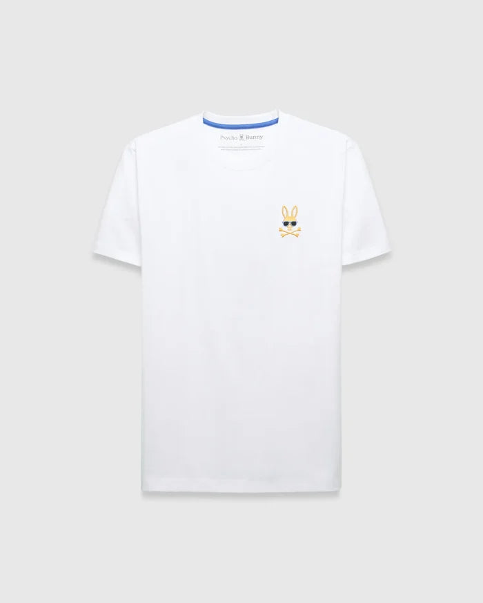 Mens Sunny Chest Graphic Tee, a classic fit white jersey t-shirt featuring a small embroidered gold Psycho Bunny skull logo with black sunglasses and white crossbones on the left chest, with blue inner collar trim.