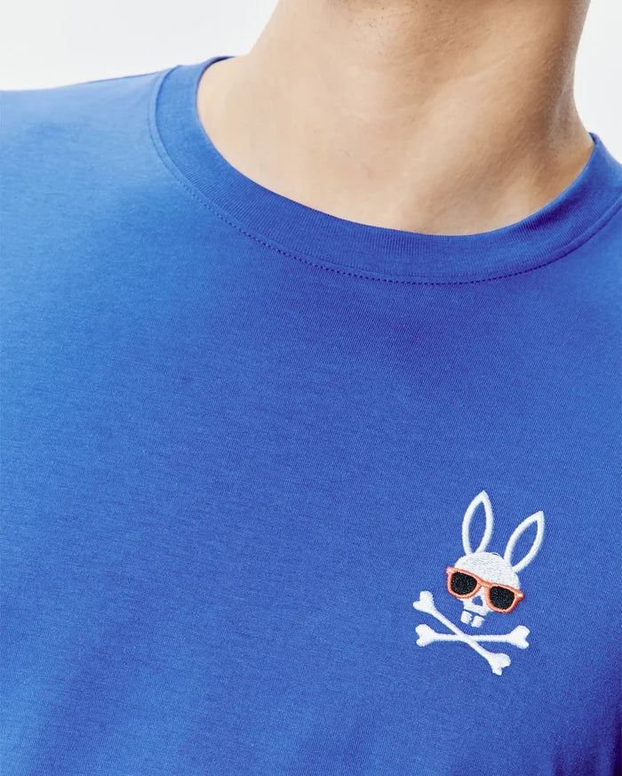 Royal blue classic fit jersey knit T-shirt featuring a small, embroidered Psycho Bunny skull logo with orange sunglasses and white crossbones on the left chest. Mens Sunny Chest Graphic Tee.