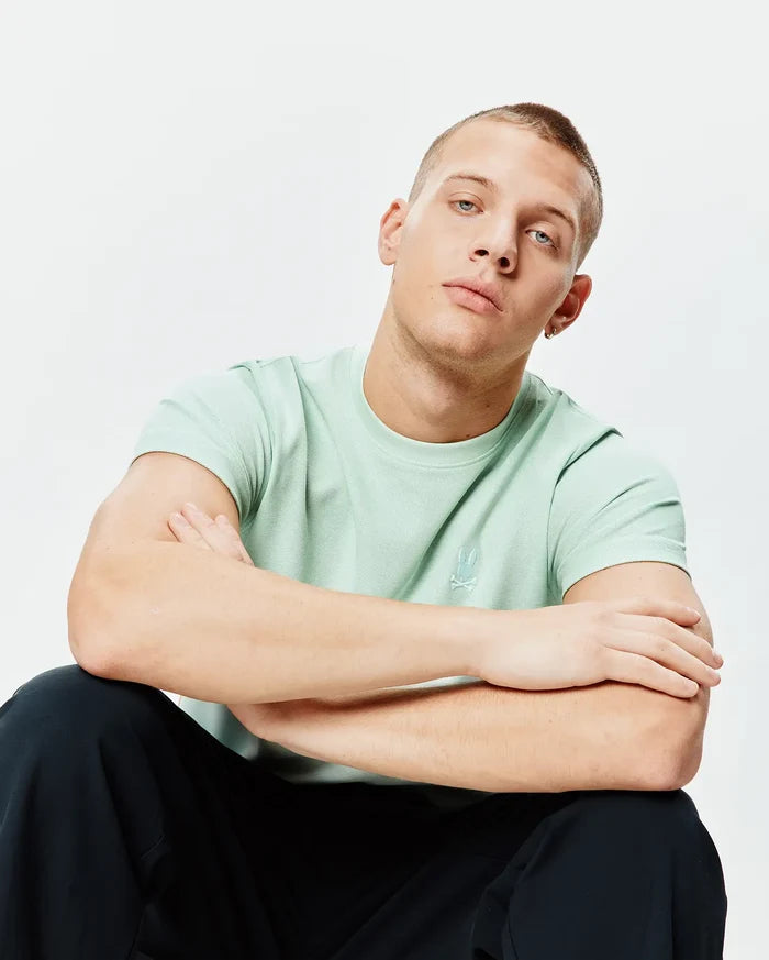 Mens Taylor Pique Tee in mint green, a classic fit pique knit t-shirt featuring a small, tonal embroidered Psycho Bunny skull logo on the left chest.